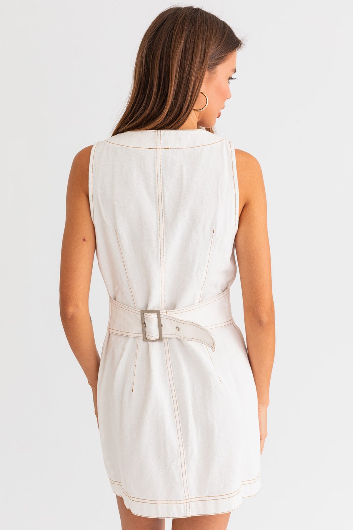 Model wearing a trendy white mini denim dress from Boho Bum Island Boutique.
