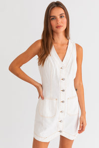 Model wearing a trendy white mini denim dress from Boho Bum Island Boutique.