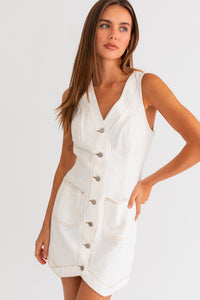 Model wearing a trendy white mini denim dress from Boho Bum Island Boutique.