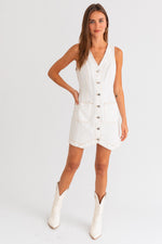 Model wearing a trendy white mini denim dress from Boho Bum Island Boutique.