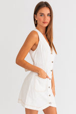 Model wearing a trendy white mini denim dress from Boho Bum Island Boutique.