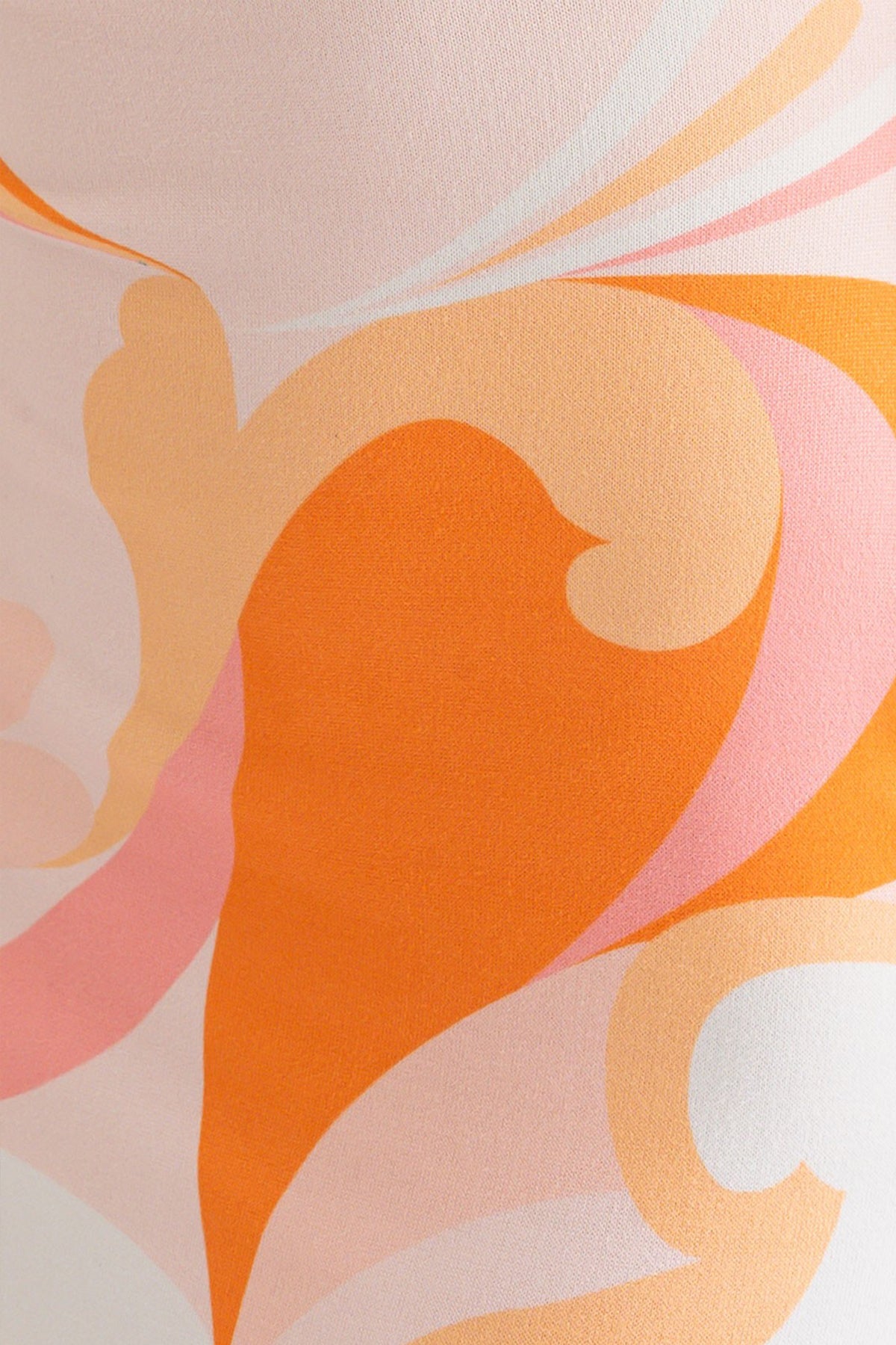 Swatch of a model wearing a halter neck cross back midi summer dress in orange and white multicolor from Boho Bum Island Boutique