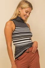 Model wearing a black & white striped turtle neck tank top from Boho Bum Island Boutique