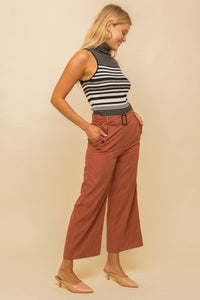 Model wearing a black & white striped turtle neck tank top from Boho Bum Island Boutique