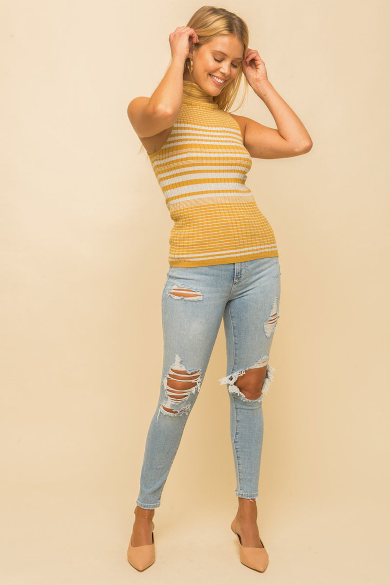 Model wearing a yellow & white striped turtle neck tank top from Boho Bum Island Boutique