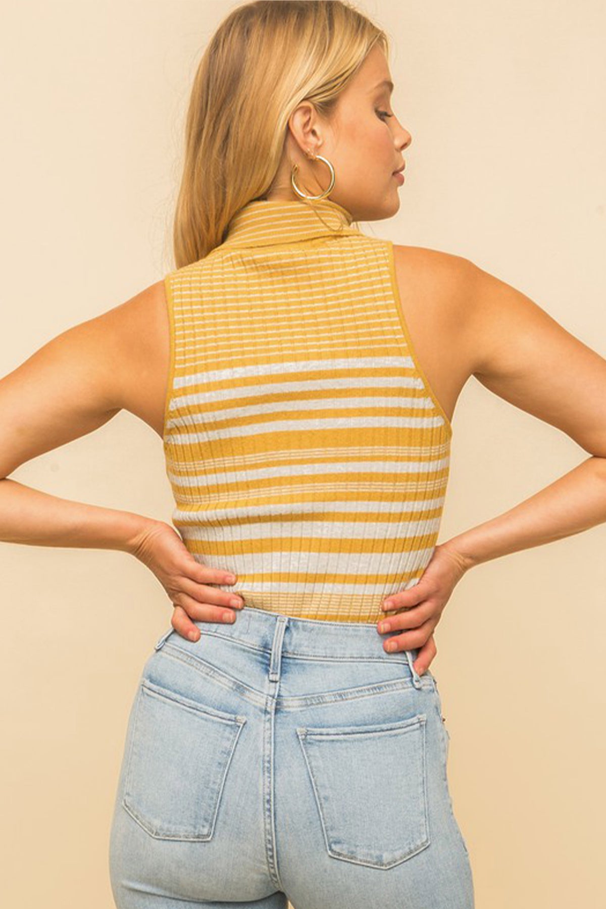 Model wearing a yellow & white striped turtle neck tank top from Boho Bum Island Boutique
