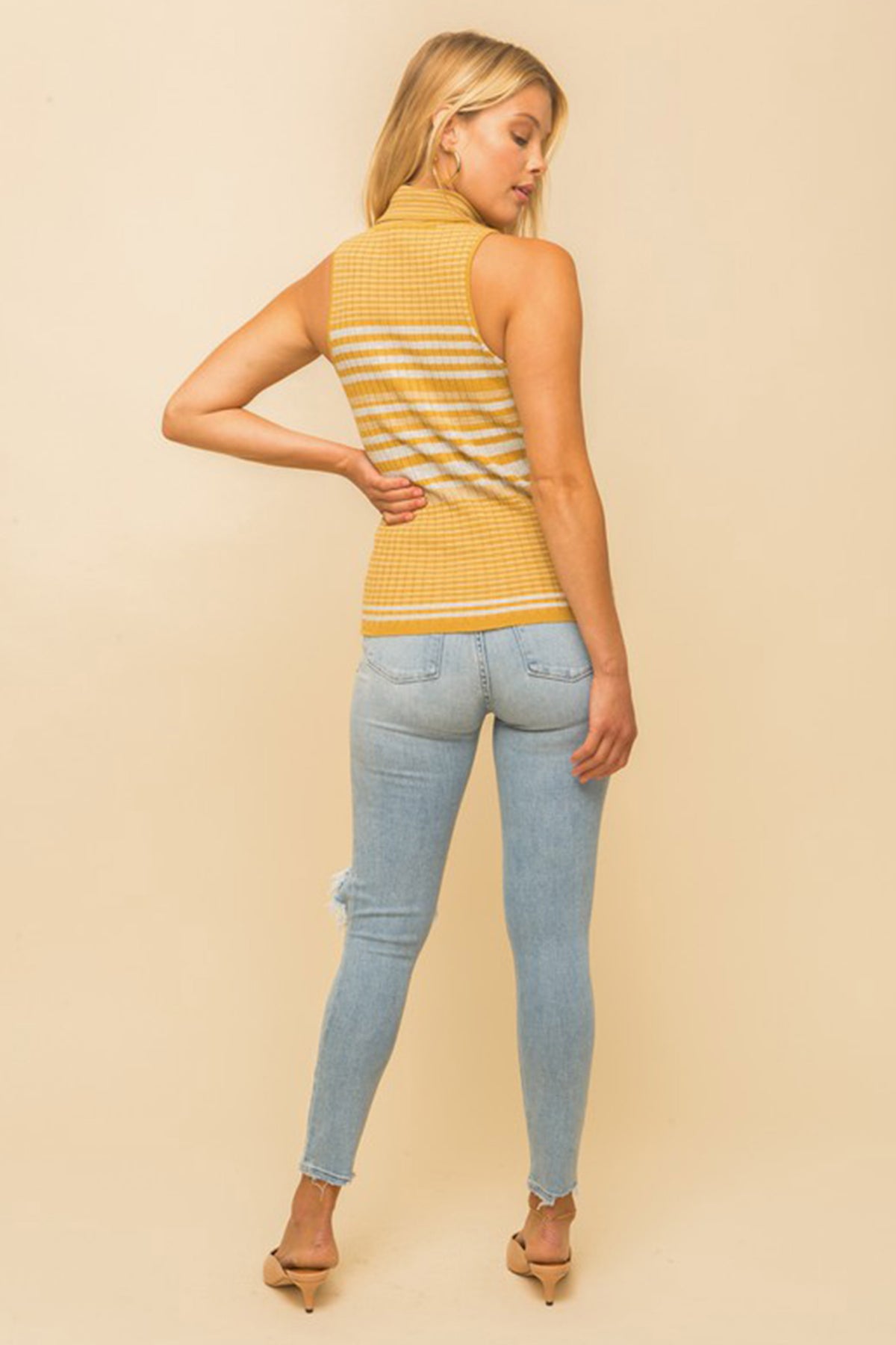 Model wearing a yellow & white striped turtle neck tank top from Boho Bum Island Boutique