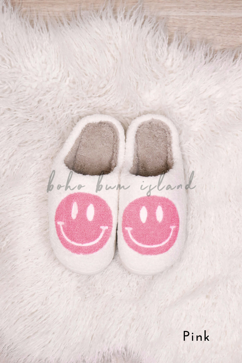 Smiley face emoji slippers in purple, blue, aqua and pink from Boho Bum Island Boutique. 