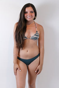 Model wearing a pullover bikini top in a lightning tie-dye print by Bettinis from Boho Bum Island boutique.